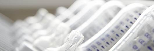 Baby's bottles on drying rack, close-up